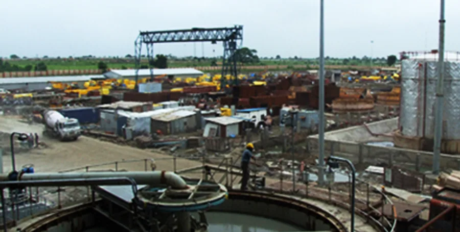Heavy construction site with structural steelwork and earthmoving equipment